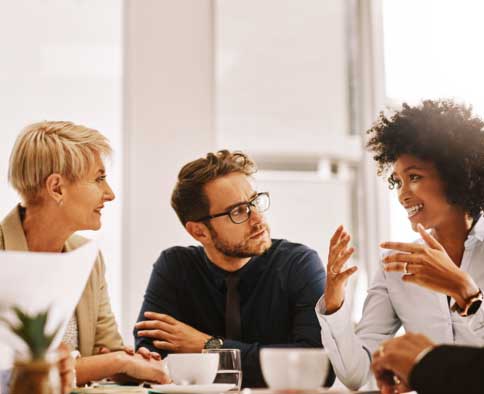 Co-workers talking at conference table